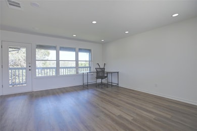 Unfurnished room with recessed lighting, dark woo