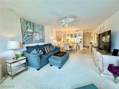 Living room with light carpet and ceiling fan