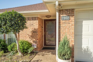 View of exterior entry with roof with shingles, a 