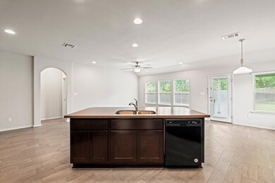 Kitchen with dishwasher, arched walkways, a ceili