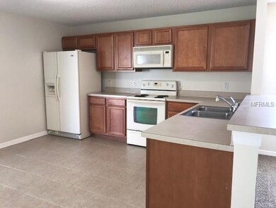Kitchen with tile flooring and sliders to covered,