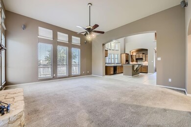 Unfurnished living room with a towering ceiling, l