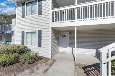 Property entrance featuring a balcony