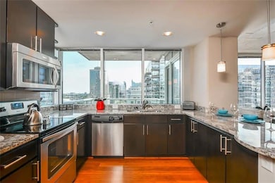 Kitchen with light stone counters, stainless steel