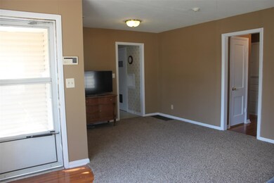 Covered Porch entry to home has beautiful hardwood