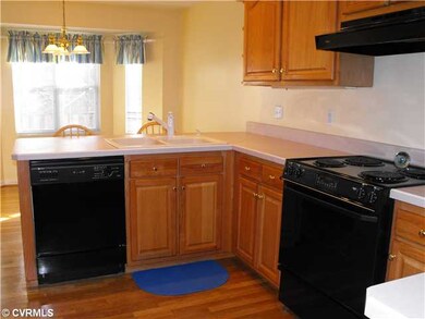 Kitchen - Features plenty of wood cabinets, corian
