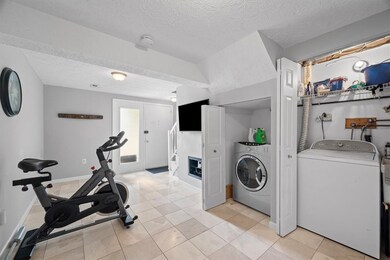 Laundry shares a space with the family room/exerci