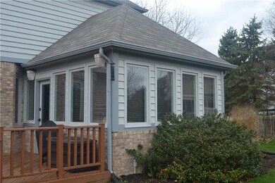 Exterior view of the sunroom's wall of windows for natural light.