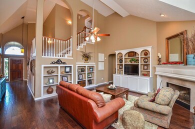 Wood flooring continues into the two story living area which features multiple built ins and gas log fireplace.