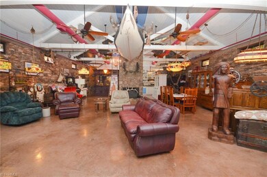 Great Room Area with Ceiling Fans, Canoe, and Other Neat Things Hanging from Ceiling.