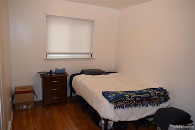Bedroom featuring dark wood-style floors