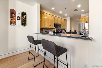 Kitchen with visible vents, a peninsula, light woo