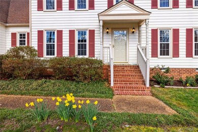 Vinyl siding, front stoop, and fresh landscaping
