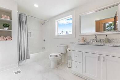 Upstairs full bath has new floors, tile, cabinetry