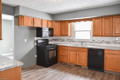 Updated eat-in kitchen with a new stove.