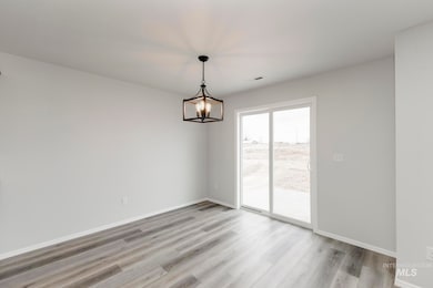 Unfurnished room featuring light wood-style floors and a chandelier