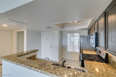 Kitchen featuring stainless steel appliances, a si