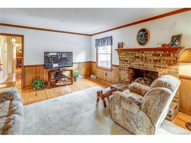 Family room has pretty hardwood floors, brick gas 