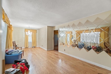 Interior space featuring baseboards, a textured ce