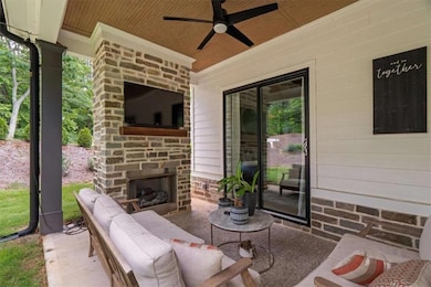 Your year-round retreat – covered patio with fireplace and tongue-and-groove ceiling