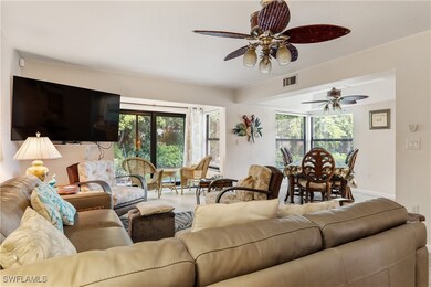 Living room featuring a ceiling fan, plenty of nat