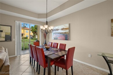 Tiled dining room featuring an inviting chandelier