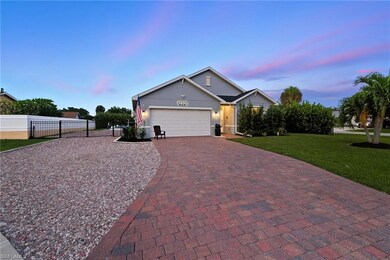 View of front of property with decorative driveway, an attached garage, and stucco siding