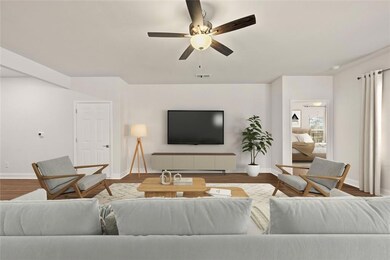 Living room with ceiling fan and hardwood / wood-s
