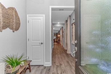Hallway with light hardwood / wood-style floors