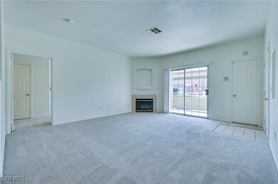 Unfurnished living room featuring carpet, a tile f