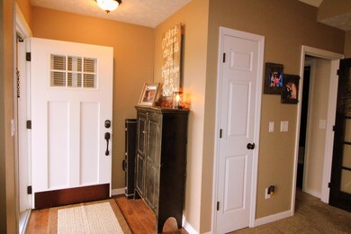 As soon as you enter you begin to see all the  upgrades starting with the front door & warm hardwood flooring in the entry..