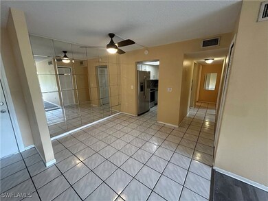 Unfurnished room with ceiling fan, light tile patt