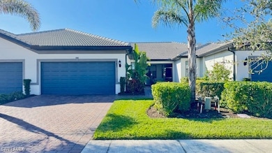 Single story home featuring a garage and a front y
