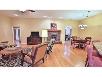 Living room features wood floors, recessed lighting, surround sound and a wood-burning fireplace.