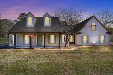 View of front of property with a lawn and a porch