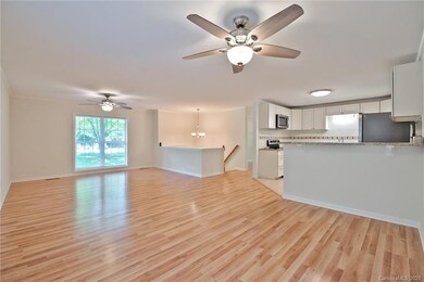 Open plan with Living Room/Dining Area featuring ceiling fans/lights & access to deck!