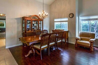 Formal dining area with a chandelier and large win