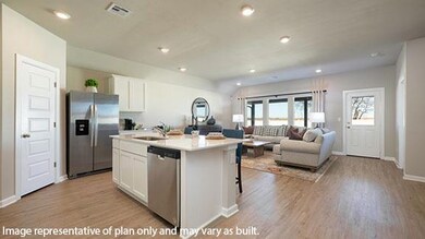Kitchen with white cabinets, recessed lighting, stainless steel appliances, open floor plan, and an island with sink