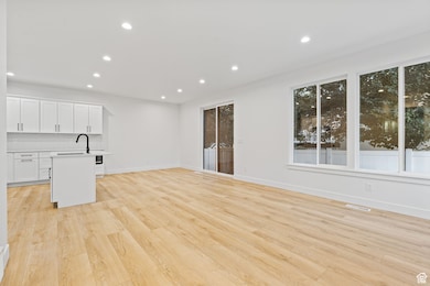 Unfurnished living room featuring recessed lighting and light wood-type flooring