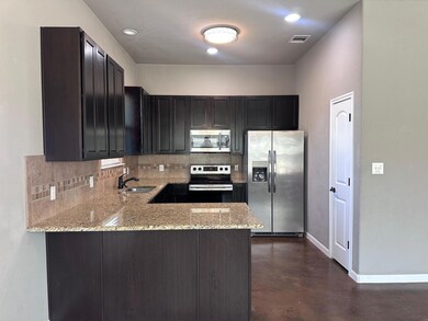 Kitchen with tasteful backsplash, stainless steel
