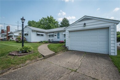 Attached garage with newer garage door and opener