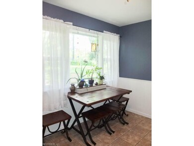 Dinette with a picture window, tile flooring and w