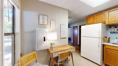 Kitchen featuring freestanding refrigerator, a pan