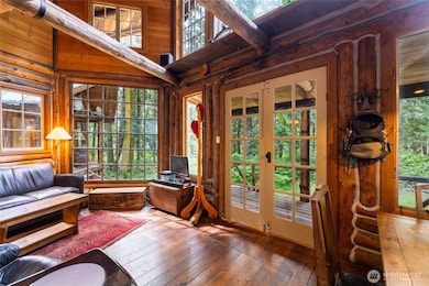 Cabin is filled with windows looking out to the beautiful woods