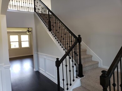 Beautiful entry with open railing staircase