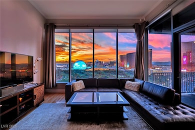 Living room featuring wood finished floors, crown