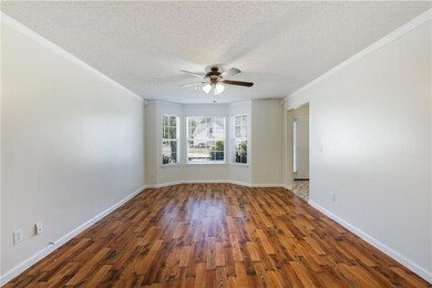 Empty room featuring wood finished floors, a textu
