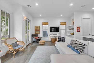 Living area with wood finished floors and recessed lighting