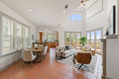Living room featuring arched walkways, light tile