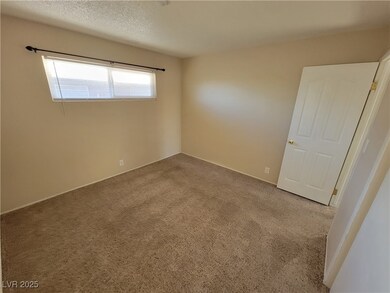 Spare room with carpet floors and a textured ceiling